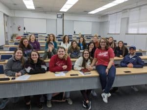 Group of Howard Payne University students smiling in a classroom setting. | HPU