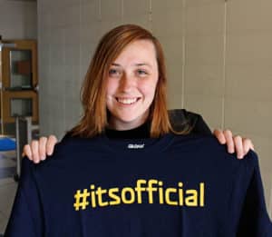 Sarah Leahart, a freshman at the HPU New Braunfels Center, displays the t-shirt students receive upon admission to the university.
