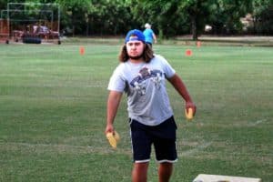 Man playing cornhole at an outdoor event at Howard Payne University. | HPU