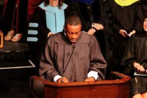 A person delivering a speech at a Howard Payne University graduation ceremony. | HPU