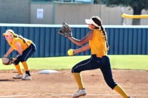 Pitcher winding up for a throw in a Howard Payne University women's softball game. | HPU