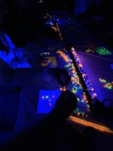 People playing bingo under black light illumination at Howard Payne University. | HPU