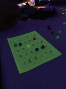 Bingo sheet illuminated by glow-in-the-dark lights with colorful markers on numbers at Howard Payne University. | HPU