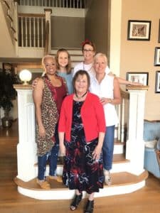 Five women smiling for a group photo on indoor stairs at Howard Payne University. | HPU