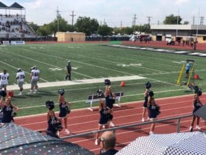 Cheerleaders performing on the sidelines of a Howard Payne University football game. | HPU