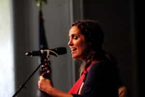 A woman speaking into a microphone on stage at Howard Payne University. | HPU