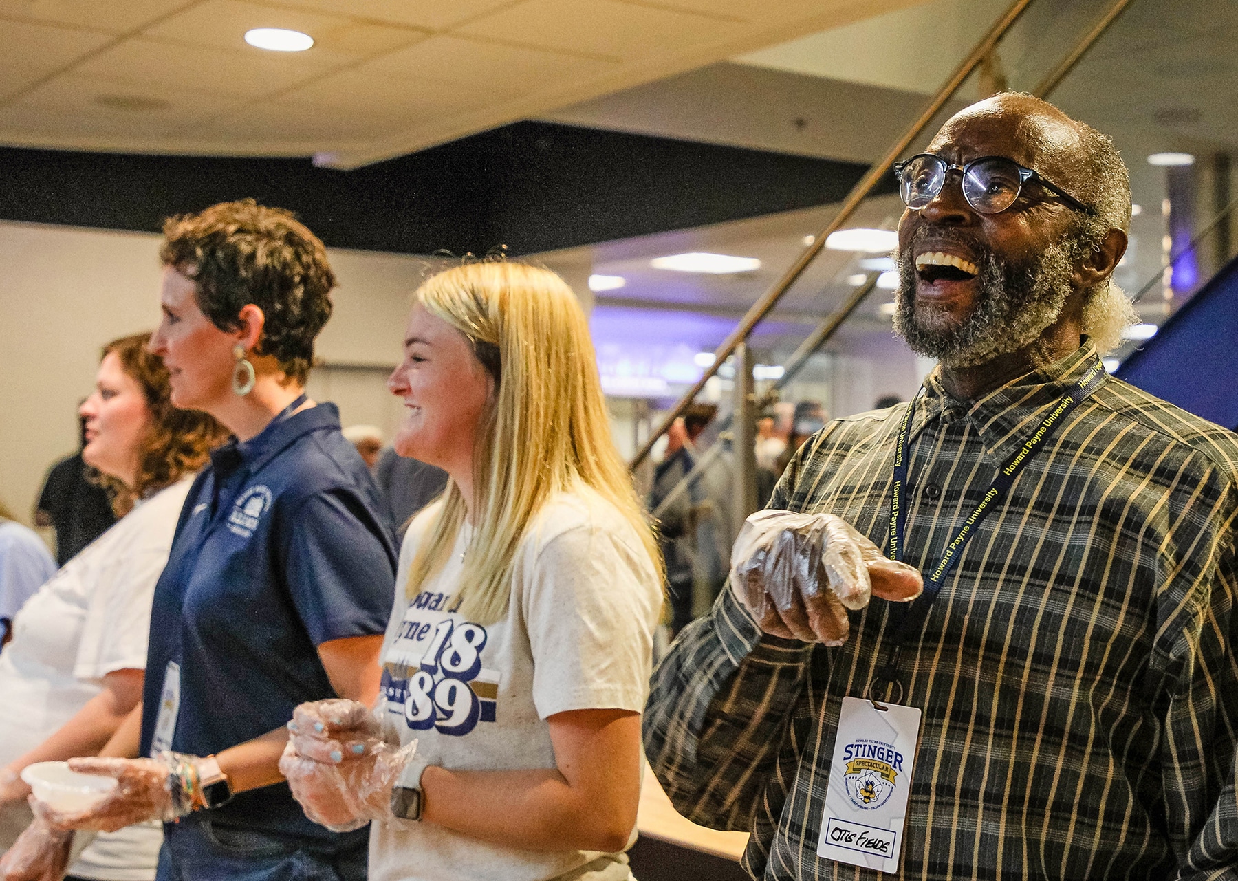 Group of Howard Payne University students engaging in a lively activity, one man laughing joyfully with others in the background. | HPU