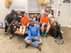 A group of Howard Payne University students smiling for a photo in a casual home setting. | HPU