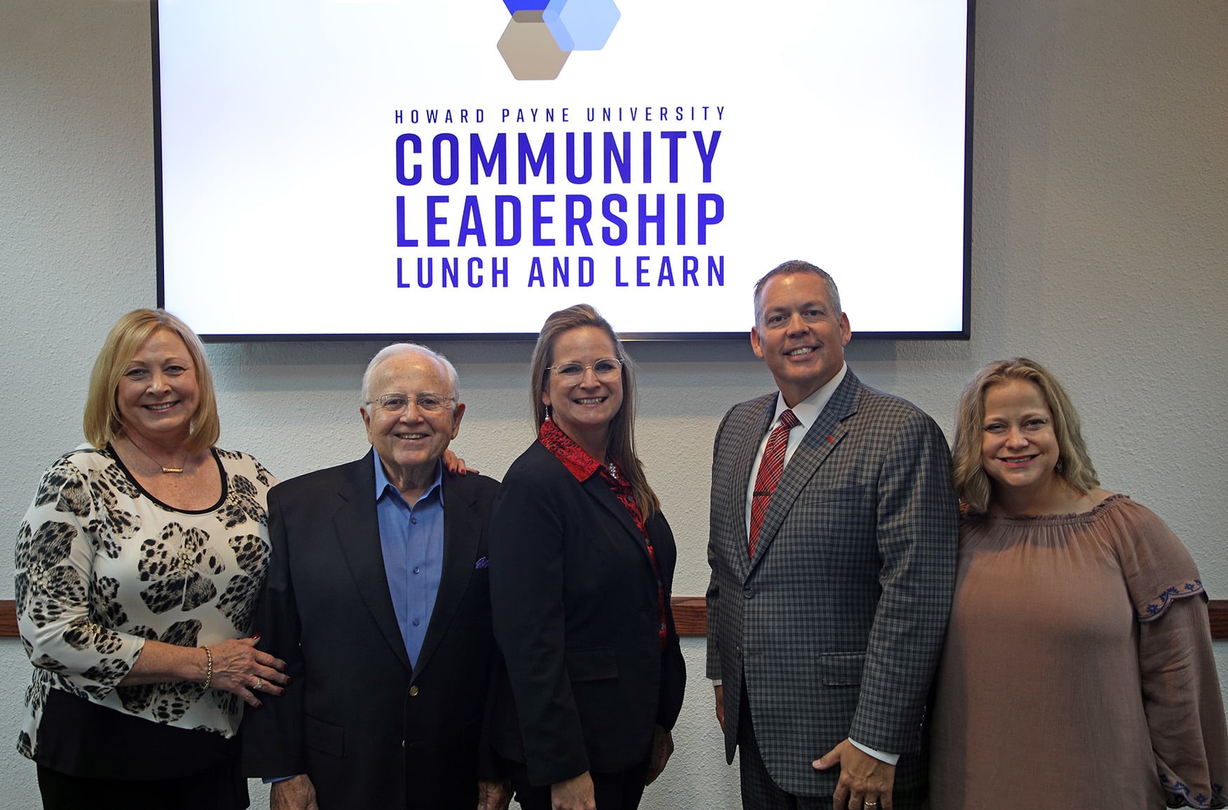 Five individuals posing for a photo at the Howard Payne University Community Leadership Lunch and Learn event. | HPU