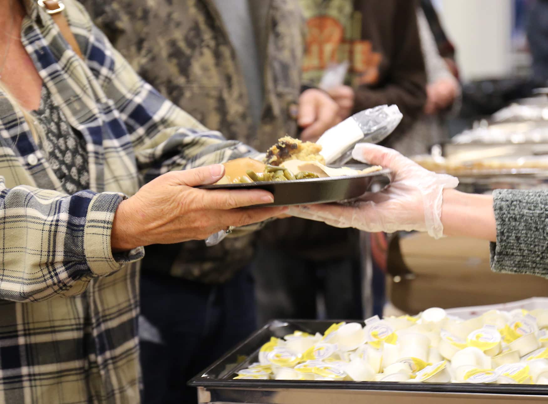 Volunteer from Howard Payne University serving food at a community event. | HPU