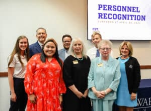 Group of people posing for a photo at a Howard Payne University personnel recognition luncheon. | HPU