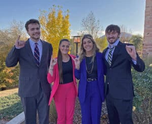 HPU’s Moot Court team consists of (from left) Mo Goff, Alli Harvey, Amber Williams and Cyah Daniel. The students show their HPU Yellow Jacket spirit by displaying the university’s “Sting ’em” hand gesture.