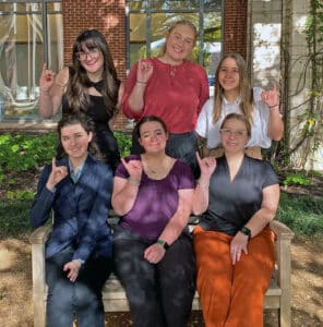 The students on HPU’s Mock Trial team are (front row, from left) Katelynn Turner, Madeline Duncan, Madison Clayton, (back row, from left) Edie Brimer, Charis Mayton and Nicole de la Houssaye. The students show their HPU Yellow Jacket spirit by displaying the “Sting ’em” hand gesture.