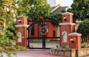 Howard Payne University's (HPU'S) Wilson Gate appears in front of Grace Chapel on a sunny day.