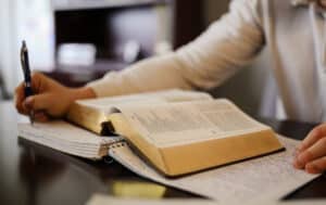 HPU Student takes notes while reading Bible.