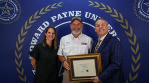 Roger Dewell (center) received HPU’s Outstanding Staff Member Award. He is pictured with Lanie Spears of Porter Insurance Agency (left) and Dr. Cory Hines (right).