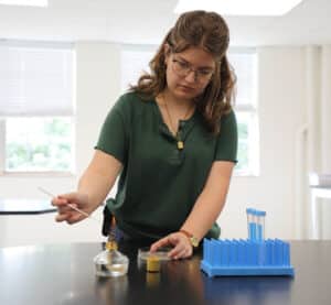 High school student works on experiment during Summer Research Symposium.