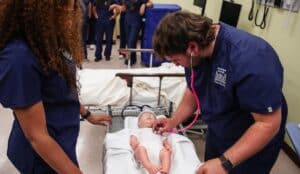 HPU students engage in a healthcare simulation in the university lab.