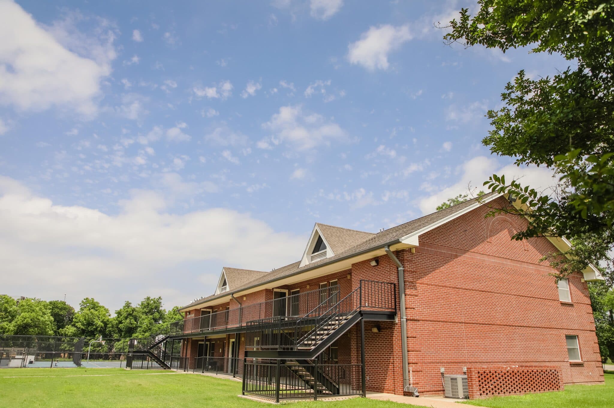 A landscape shot of the outside of one of the Newbury Apartment buildings